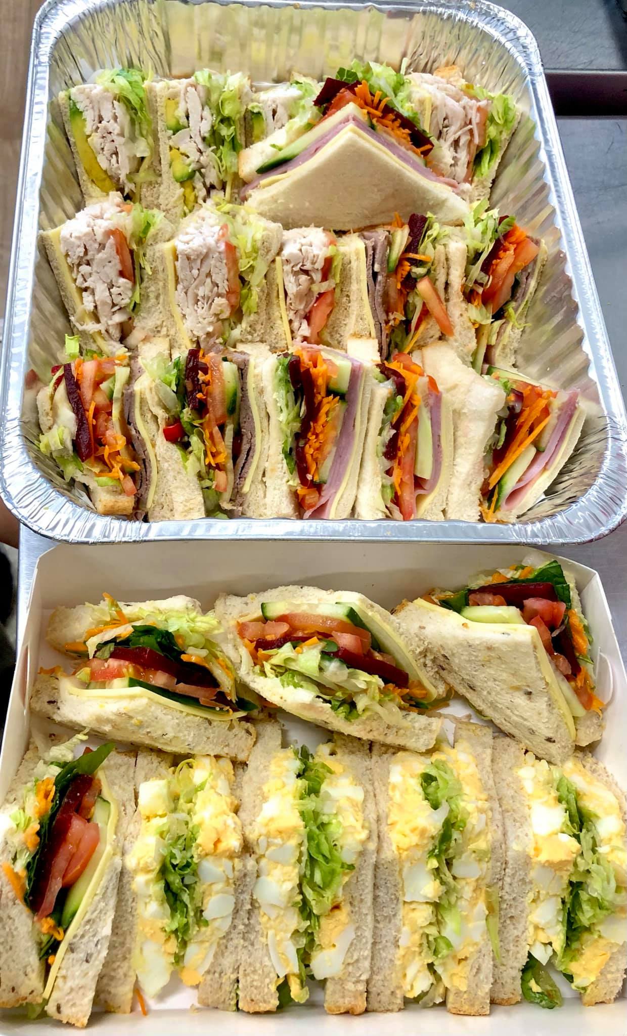 A gourmet sandwich platter with various fillings, neatly arranged.